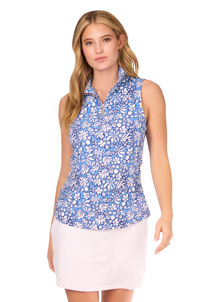 A blonde woman wearing the sun protective and navy floral Seaside 1/4 Zip Sleeveless Sport Top and White Skort from Cabana Life on a white background.