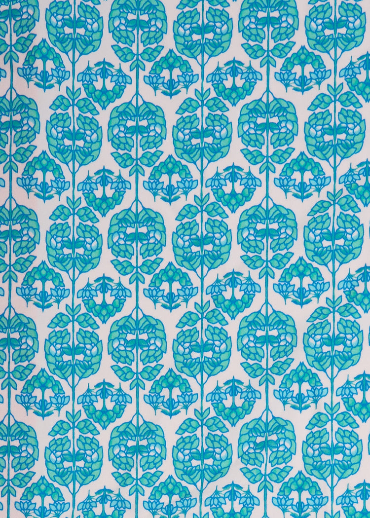 A close up of the UPF 50+ green and blue printed fabric on the Cabana Life Rosemary Beach Embroidered Tunic Dress.