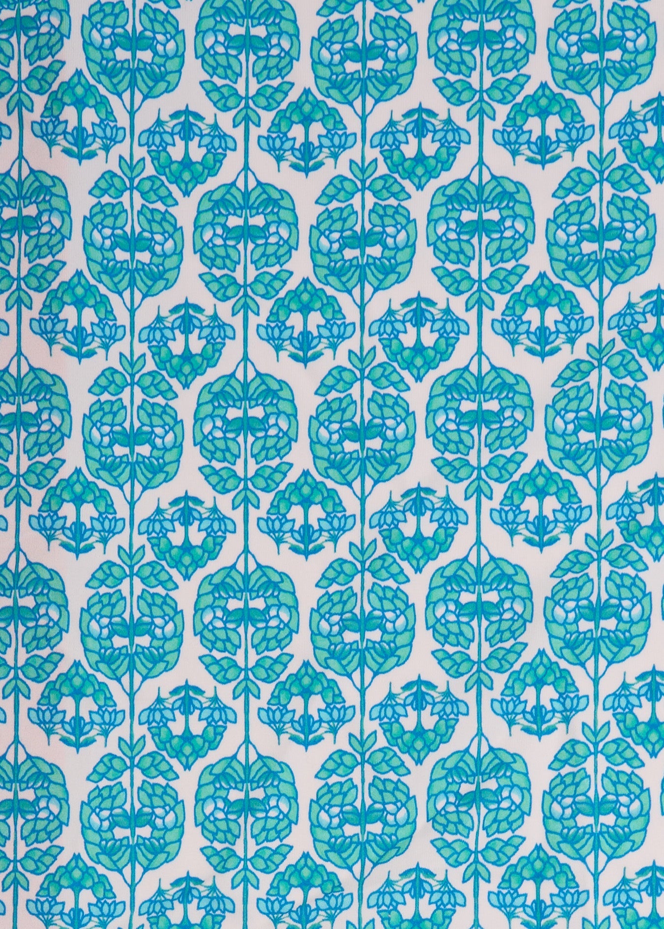 A close up of the UPF 50+ green and blue printed fabric on the Cabana Life Rosemary Beach Embroidered Tankini Top.