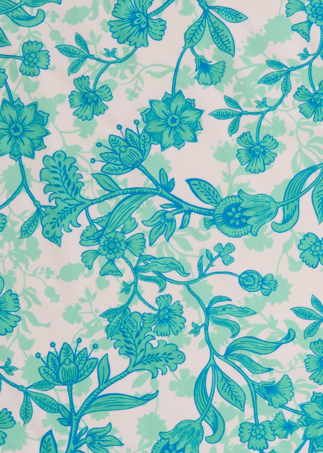 A close up of the UPF 50+ green and blue floral fabric on the Cabana Life Rosemary Beach Ruffle Short Sleeve Dress.