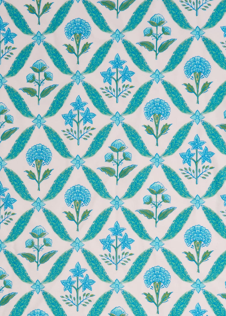 A close up of the sun protective green and blue floral tile pattern on the Cabana Life Rosemary Beach Smocked Maxi Dress.