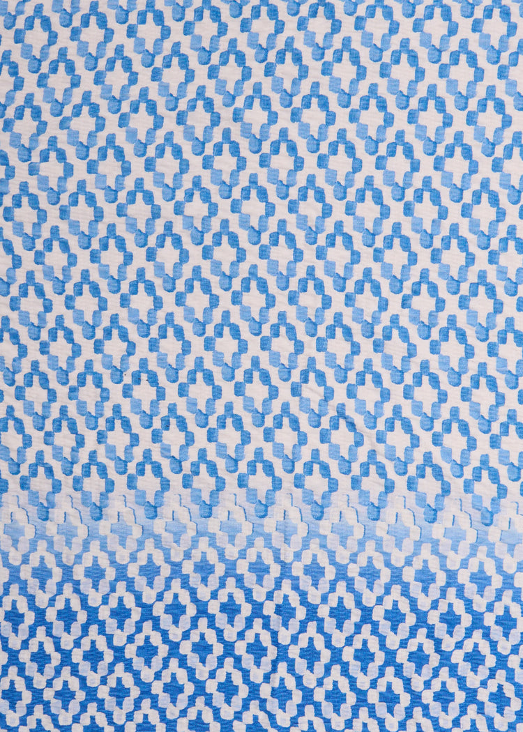 A close up of Cabana Life's Seaside light blue and white watercolor diamond print on a UPF 50+ gauze fabric. 