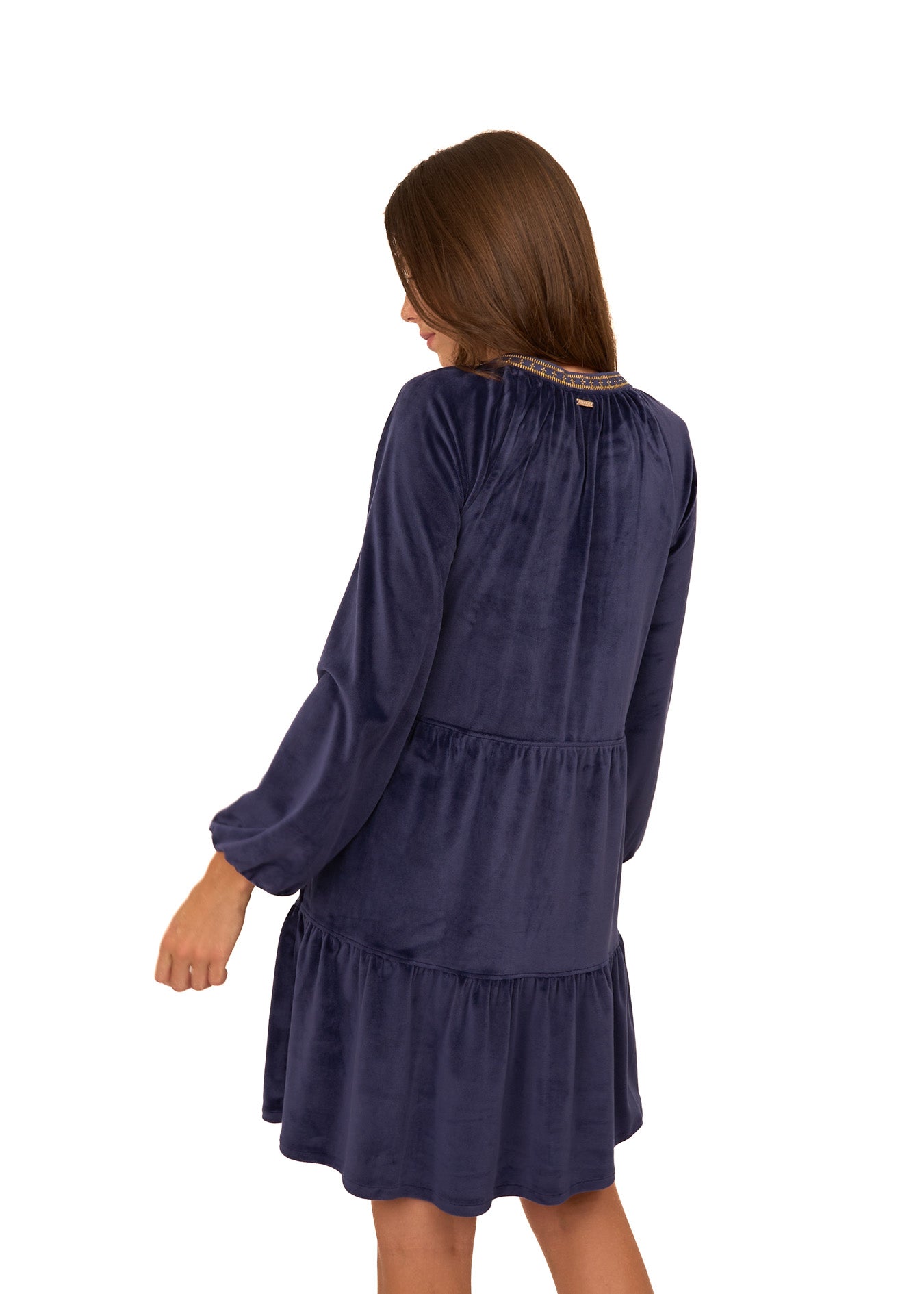 The back of a brunette woman wearing the sun protective Navy Embroidered Velvet Tiered Dress from Cabana Life on a white background.