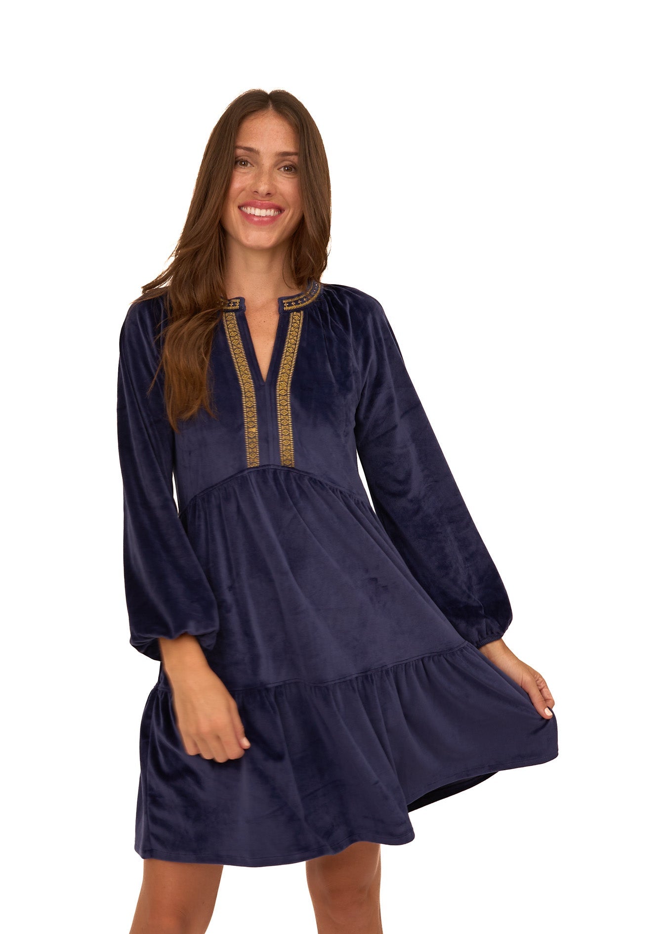 A brunette woman swinging in the sun protective Navy Embroidered Velvet Tiered Dress from Cabana Life on a white background.