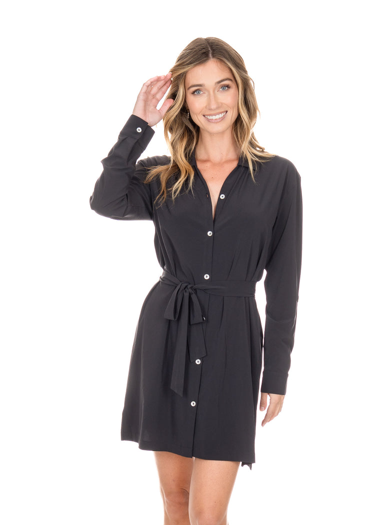 Blonde woman wearing the Black Button Down Shirt Dress while smiling with her hand in her hair.