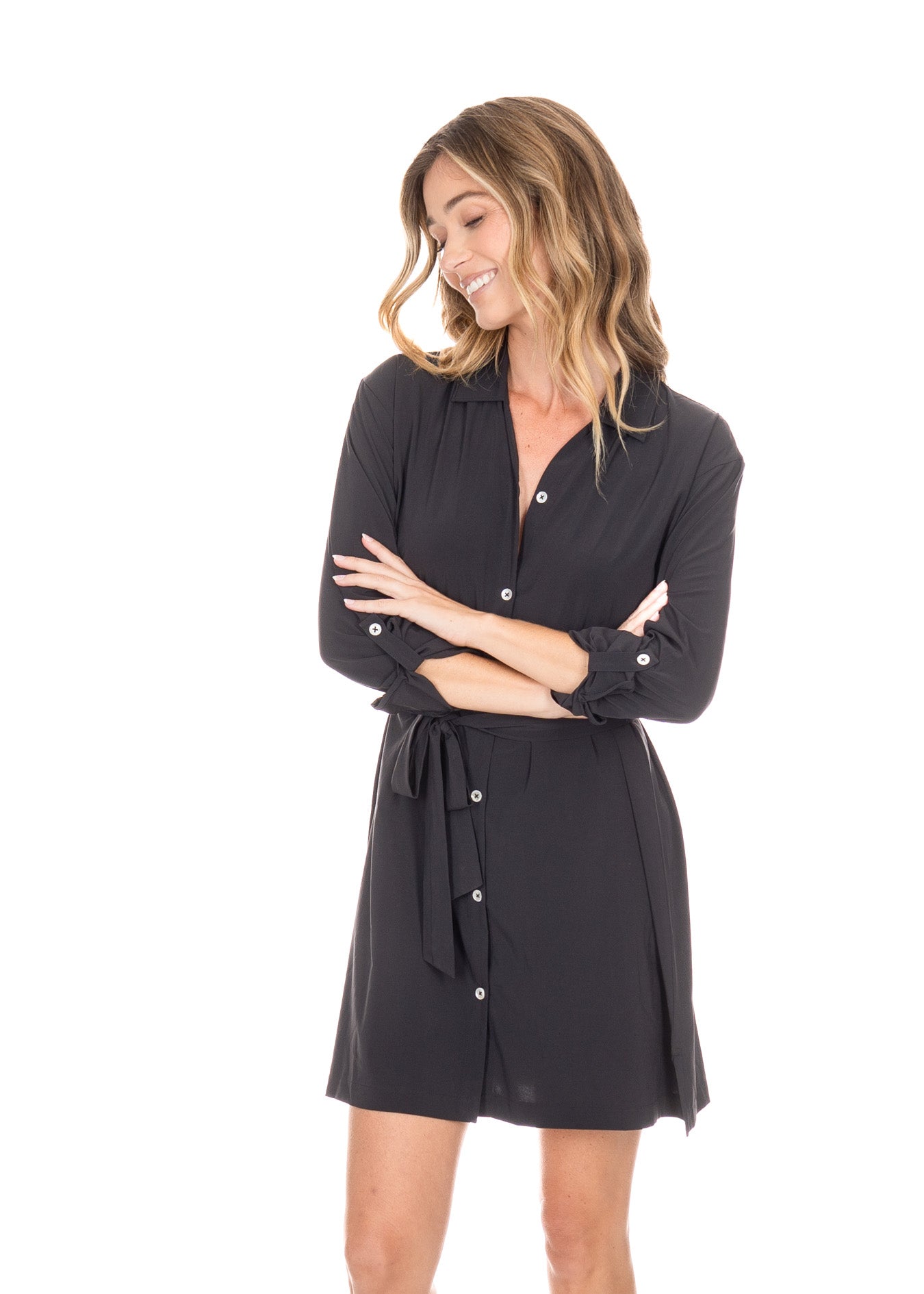 Blonde woman wearing the Black Button Down Shirt Dress with arms crossed showing button closures on sleeves. 