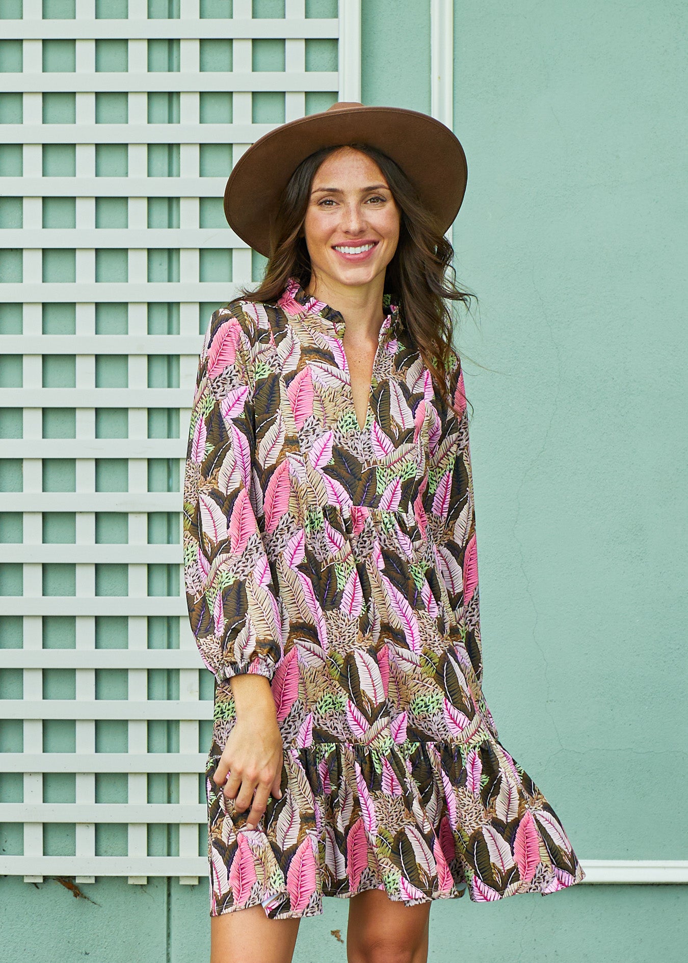 A brunette woman in front of a green building wearing Cabana Life's sun protective Myers Relaxed Dress.