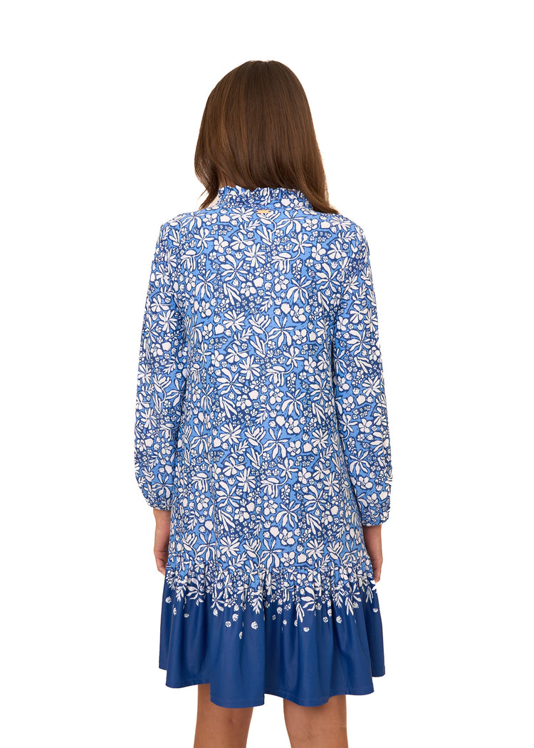 The back of a brunette woman wearing Cabana Life's sun protective Seaside Floral Relaxed Dress on a white background.