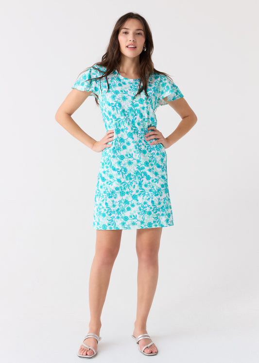 A brunette woman with hands on her hips wearing the Cabana Life sun protective Rosemary Beach Ruffle Short Sleeve Dress.