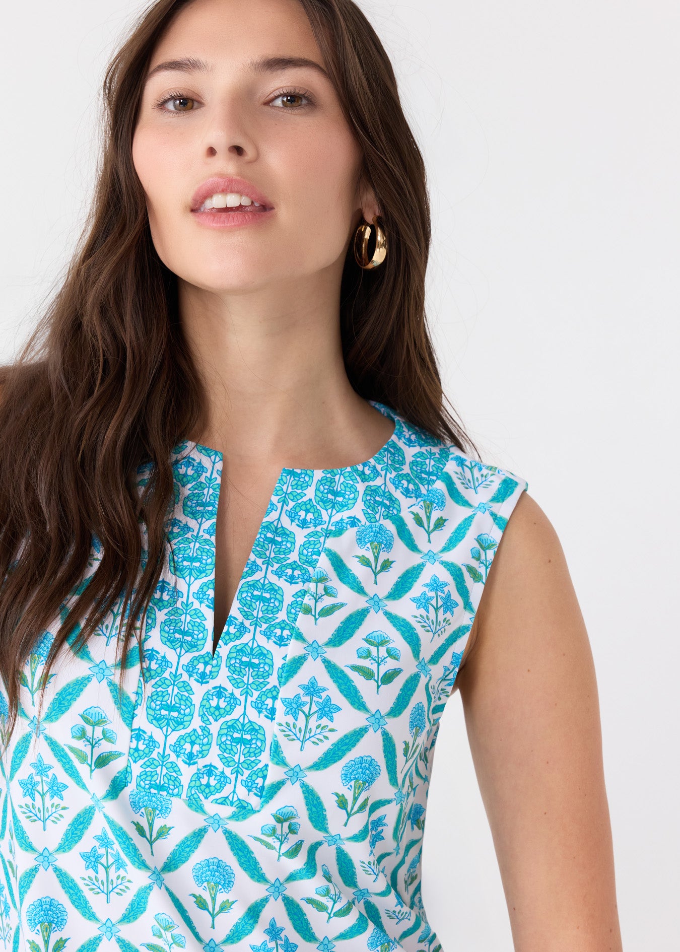 A brunette woman wearing the Cabana Life sun protective Rosemary Beach Sleeveless Tunic Dress.