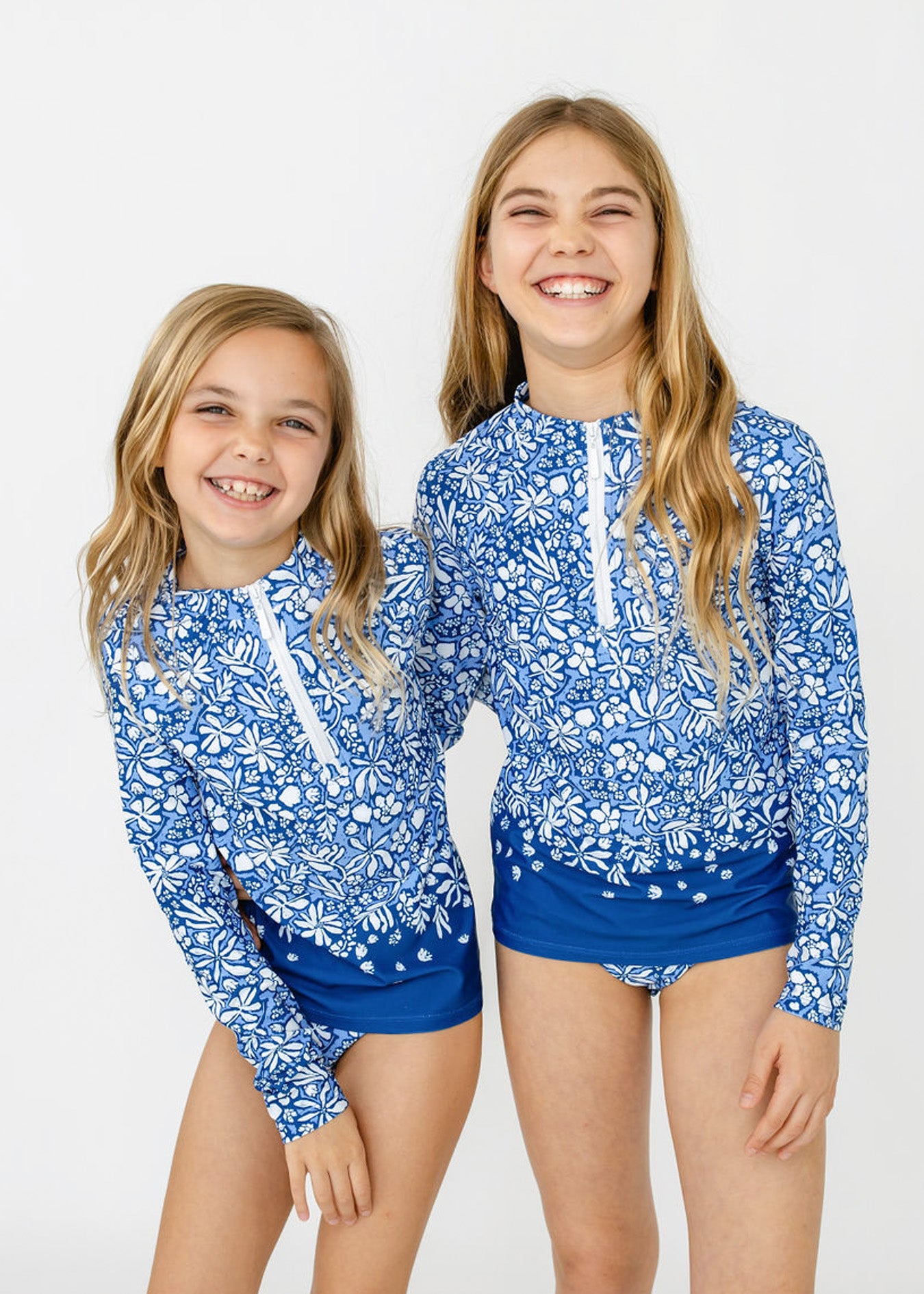 Blonde girls wear Cabana Life's sun protective Girls Seaside 3-Piece Long Sleeve Rashguard Set.