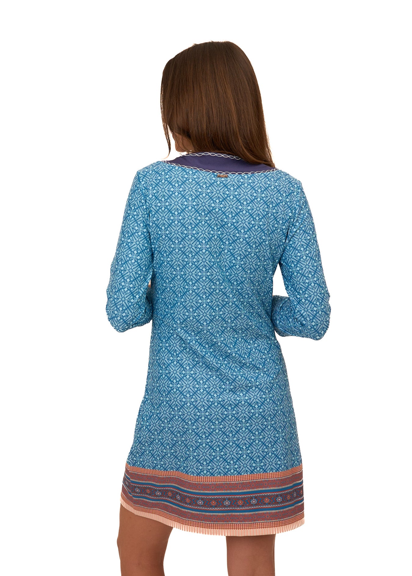 The back of a brunette woman wearing Cabana Life's sun protective Camden Leaf Embroidered Tunic Dress on a white background.