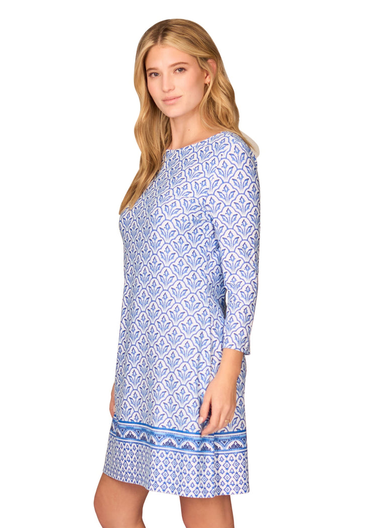 The side of a blonde woman wearing the sun protective Blue Cabana Shift Dress from Cabana Life on a white background.