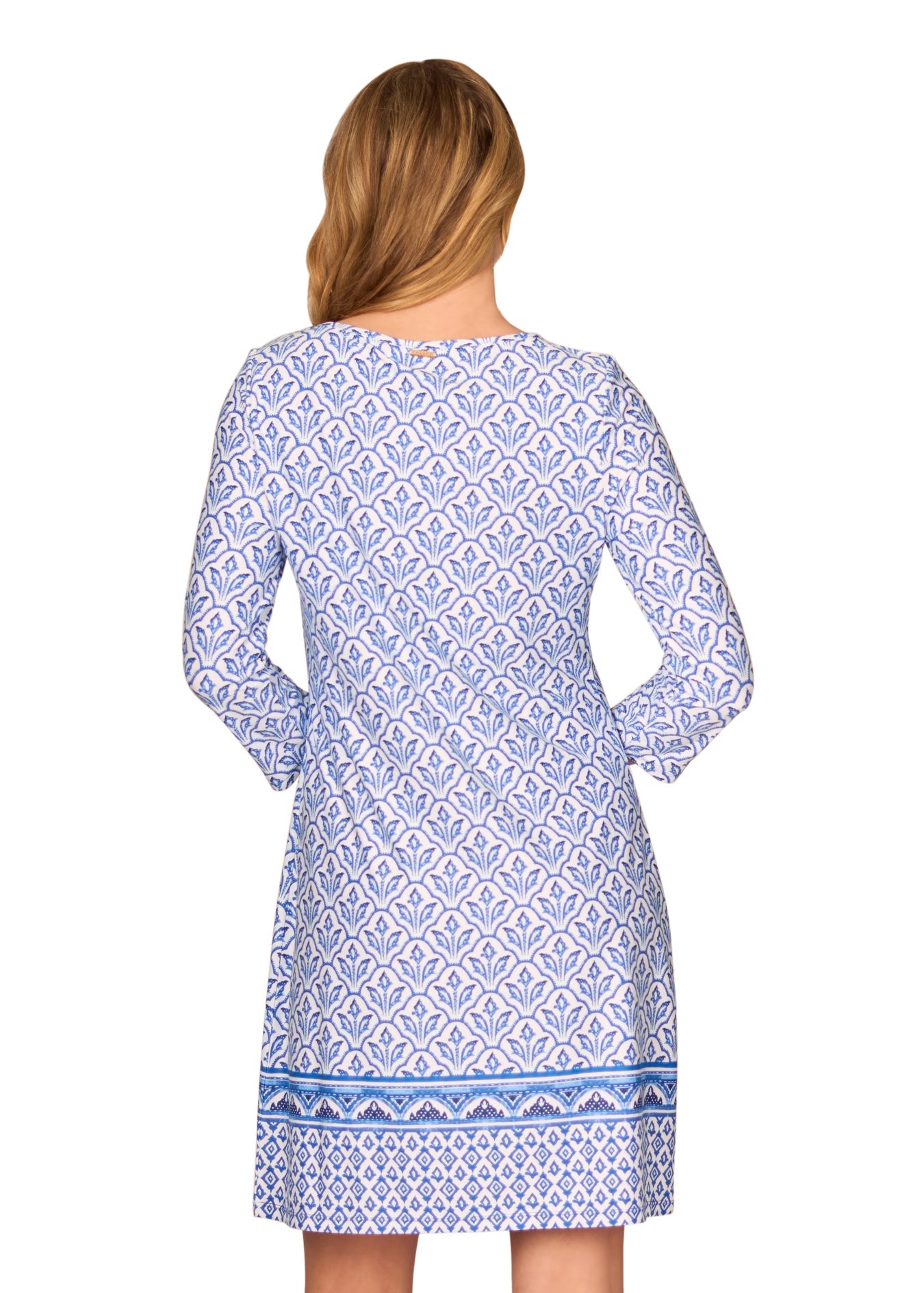 The back of a blonde woman wearing the sun protective Blue Cabana Shift Dress from Cabana Life on a white background.