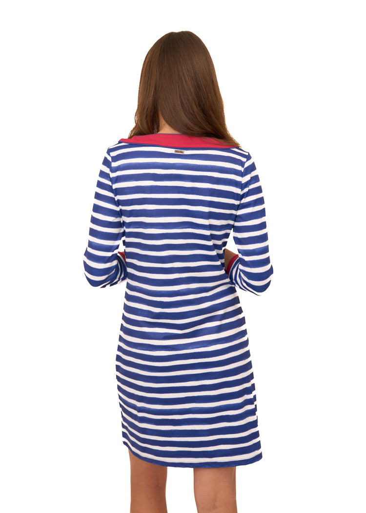 The back of a brunette woman wearing Cabana Life's sun protective Watercolor Stripe Cabana Shift Dress on a white background.