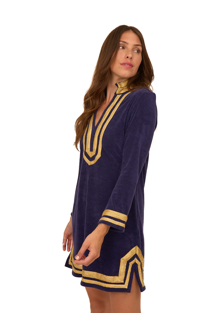 A brunette woman looking to the side wearing the cozy, sun protective Cabana Life Navy/Gold Terry Tunic.