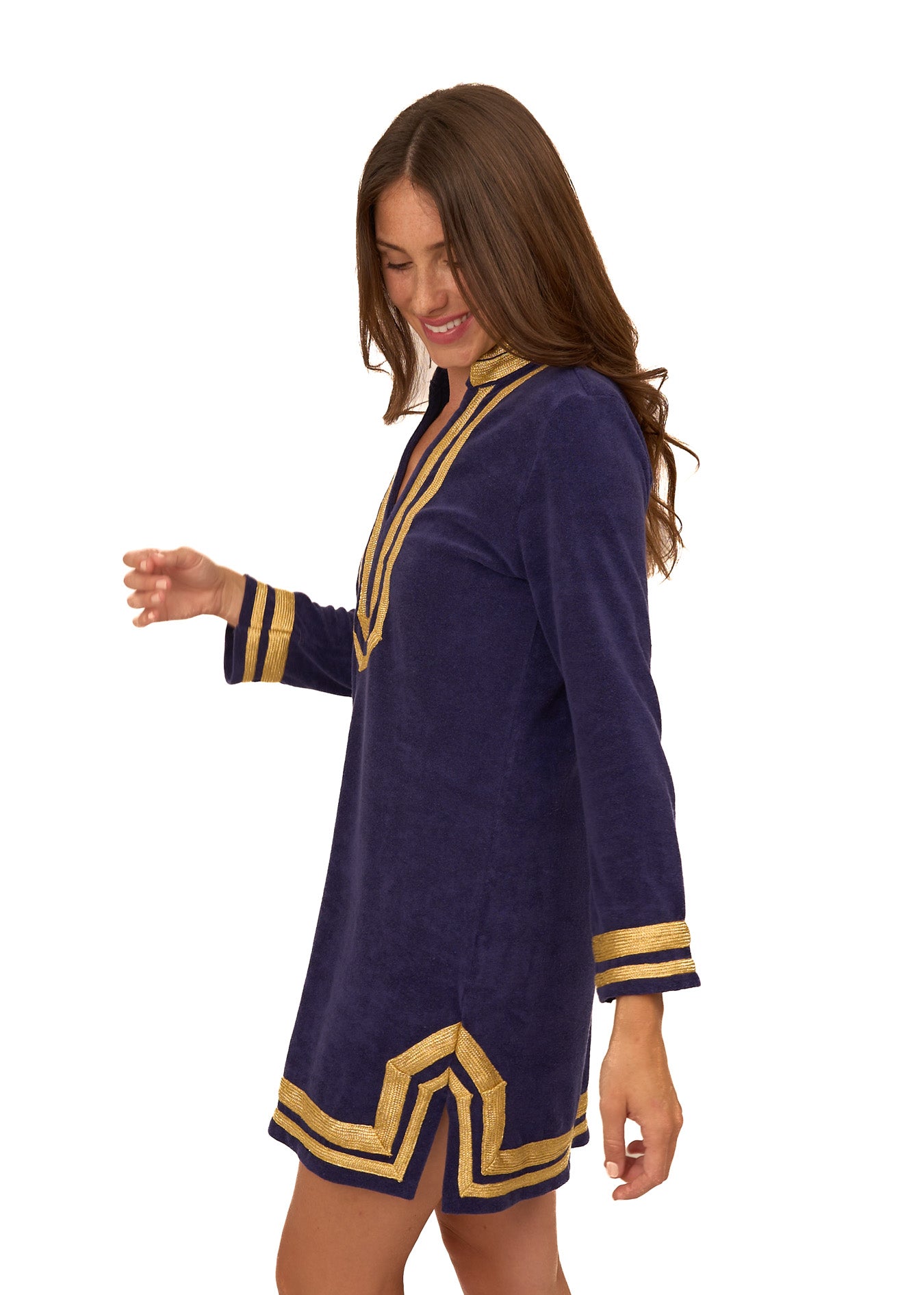 The side of a brunette woman walking wearing the cozy, sun protective Cabana Life Navy/Gold Terry Tunic.