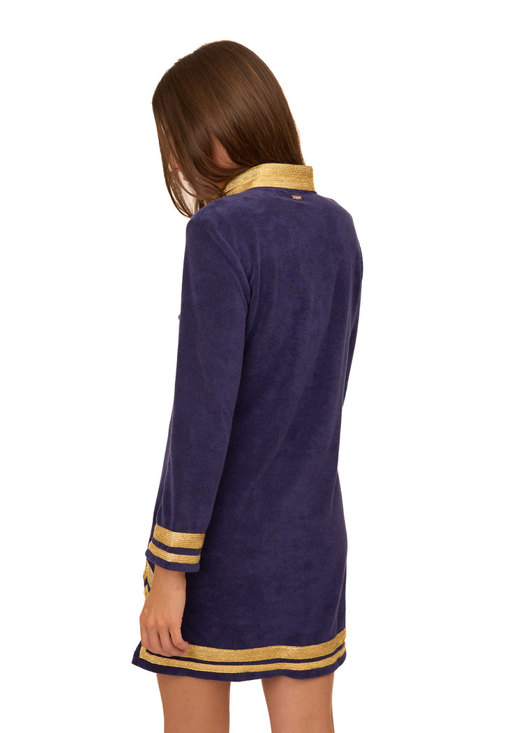 The back of a brunette woman wearing the cozy, sun protective Cabana Life Navy/Gold Terry Tunic.