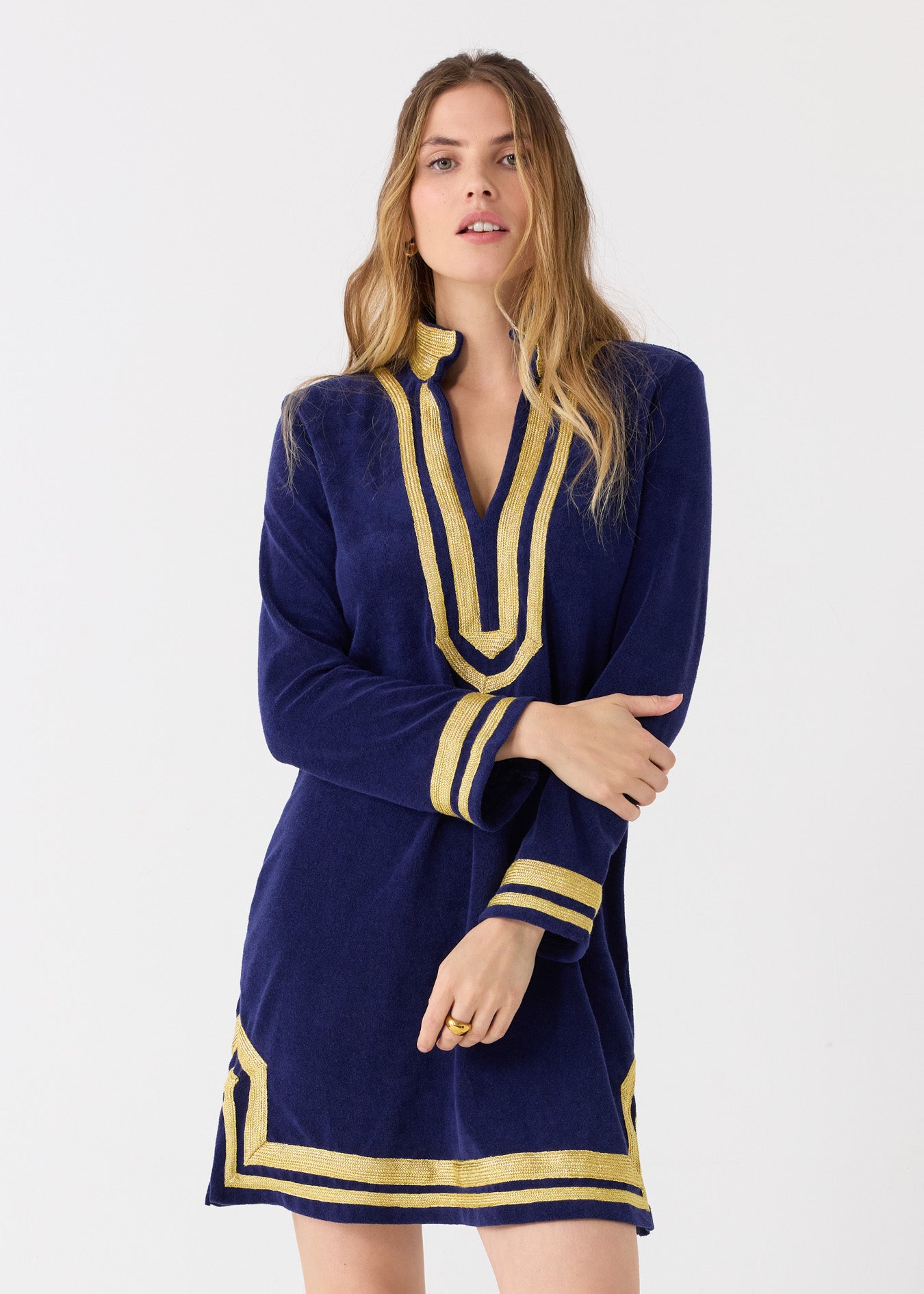 A blonde woman wearing the sun protective Cabana Life Navy/Gold Terry Tunic. 