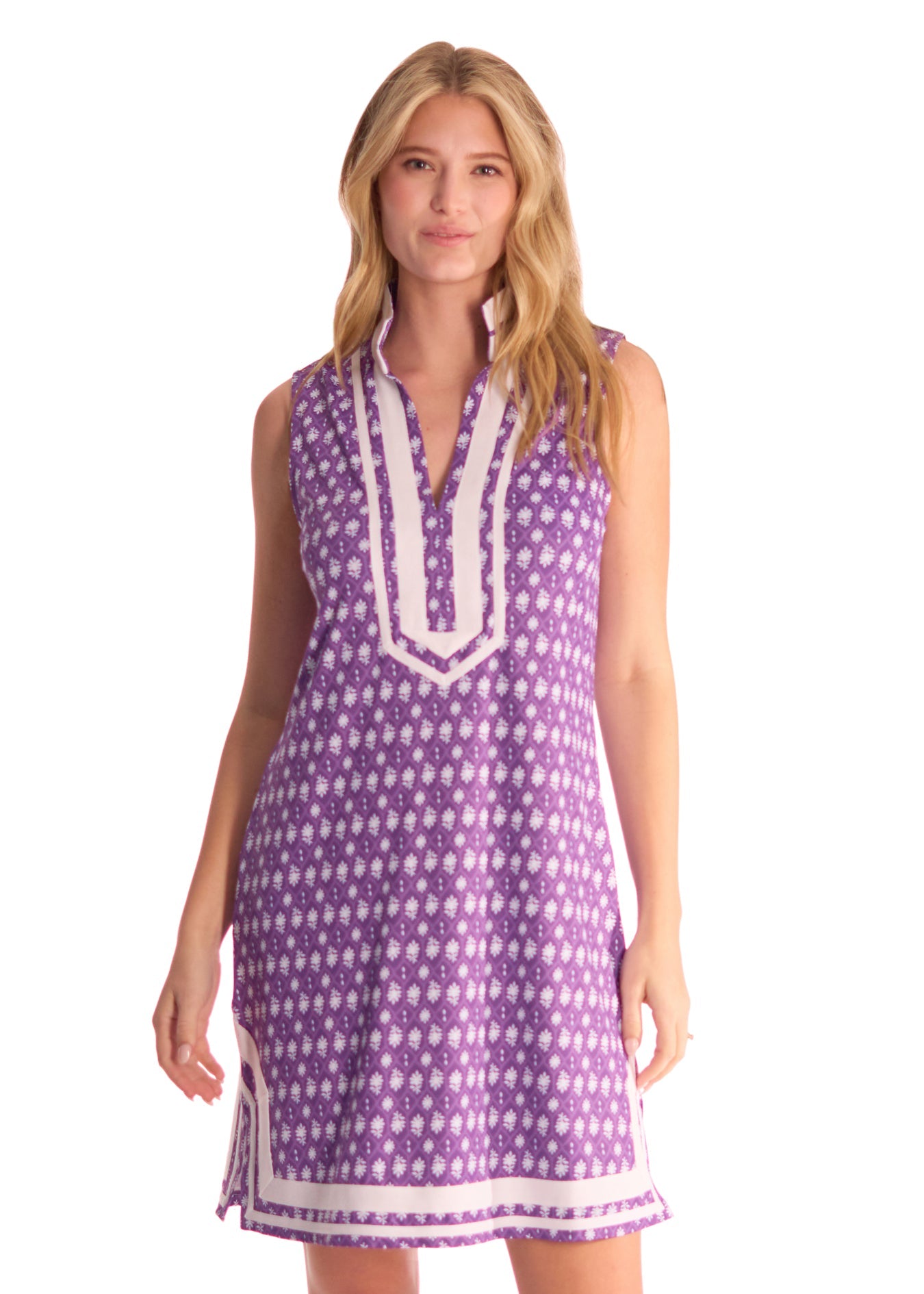 A blonde woman wearing the sun protective Purple Sleeveless Tunic Dress from Cabana Life on a white background.