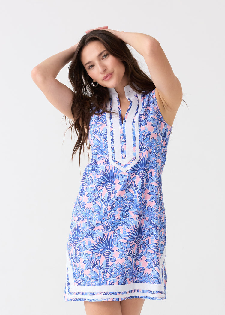 A brunette woman with her arms up wearing the Cabana Life sun protective Palm Beach Sleeveless Tunic Dress.