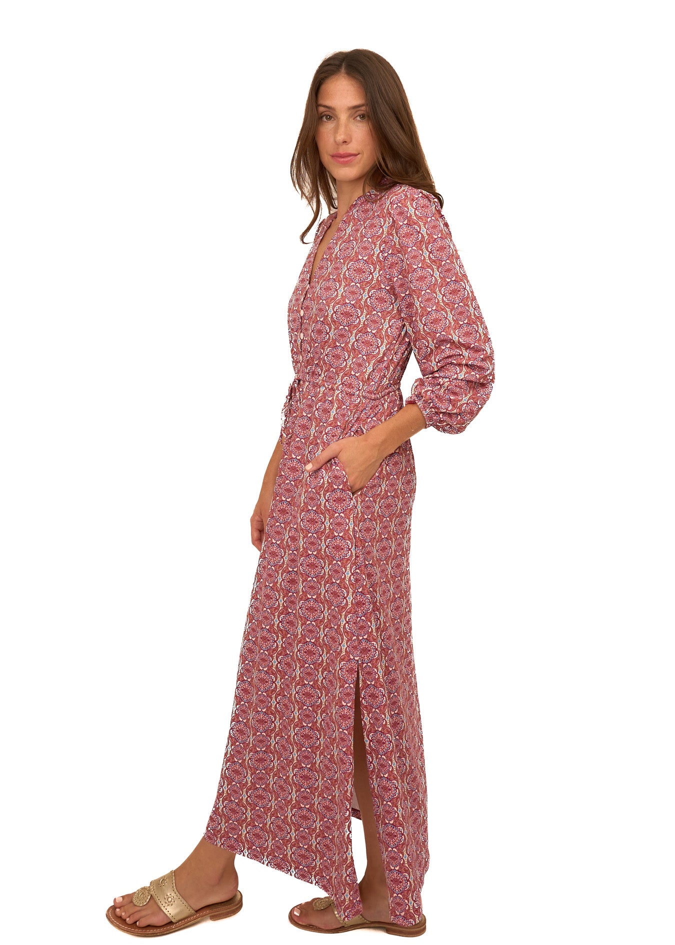 The side of a brunette woman wearing Cabana Life's sun protective Camden Geo Button Down Maxi Dress with her hand in pocket on a white background.