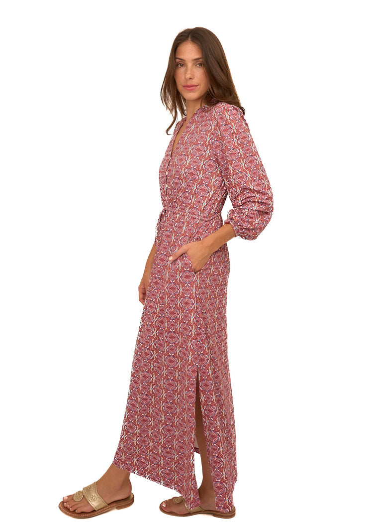 The side of a brunette woman wearing Cabana Life's sun protective Camden Geo Button Down Maxi Dress with her hand in pocket on a white background.