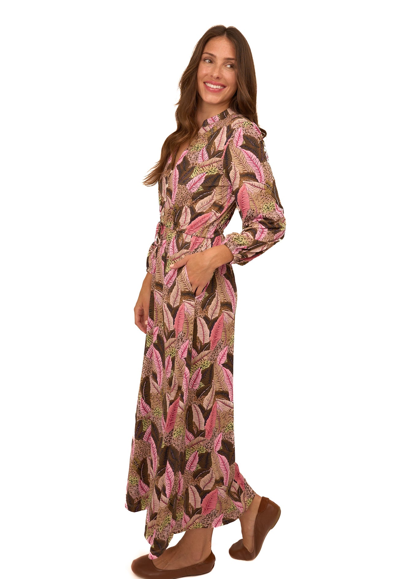 The side of a brunette woman wearing Cabana Life's sun protective Myers Button Down Maxi Dress with her hand in a pocket on a white background.