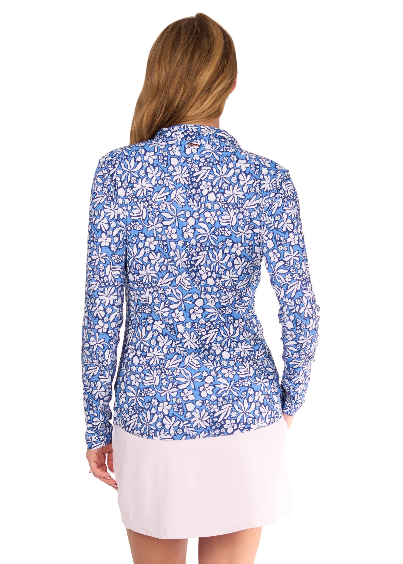 The back of a blonde woman wearing the sun protective & navy Seaside Floral 1/4 Zip Sport Top and White 14" Skort from Cabana Life on a white background.