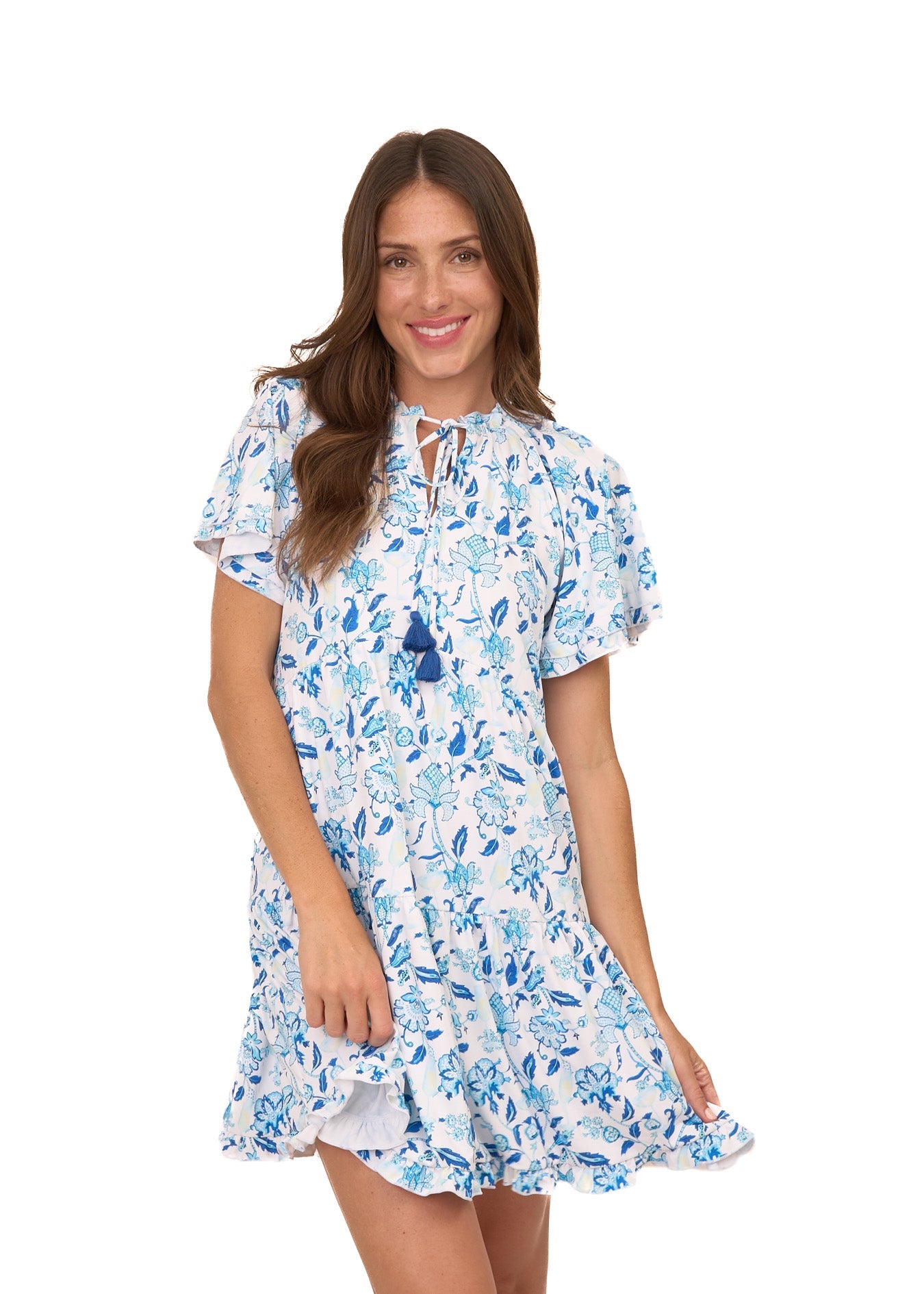 A brunette woman wearing the sun protective Bubbly Short Sleeve Tiered Ruffle Dress from Cabana Life on a white background.