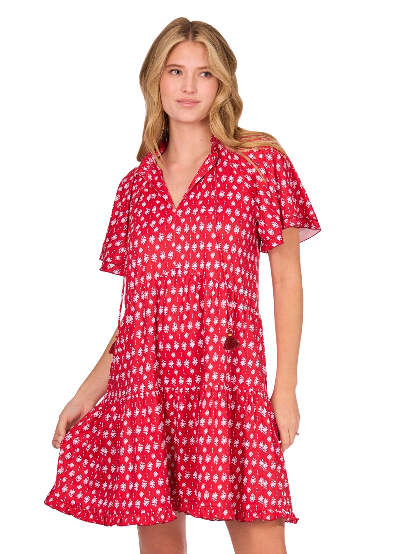 A blonde woman wearing the sun protective Crimson Short Sleeve Tiered Dress from Cabana Life on a white background.