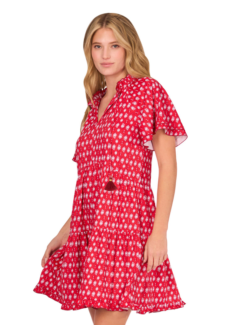 The side of a blonde woman wearing the sun protective Crimson Short Sleeve Tiered Dress from Cabana Life on a white background.