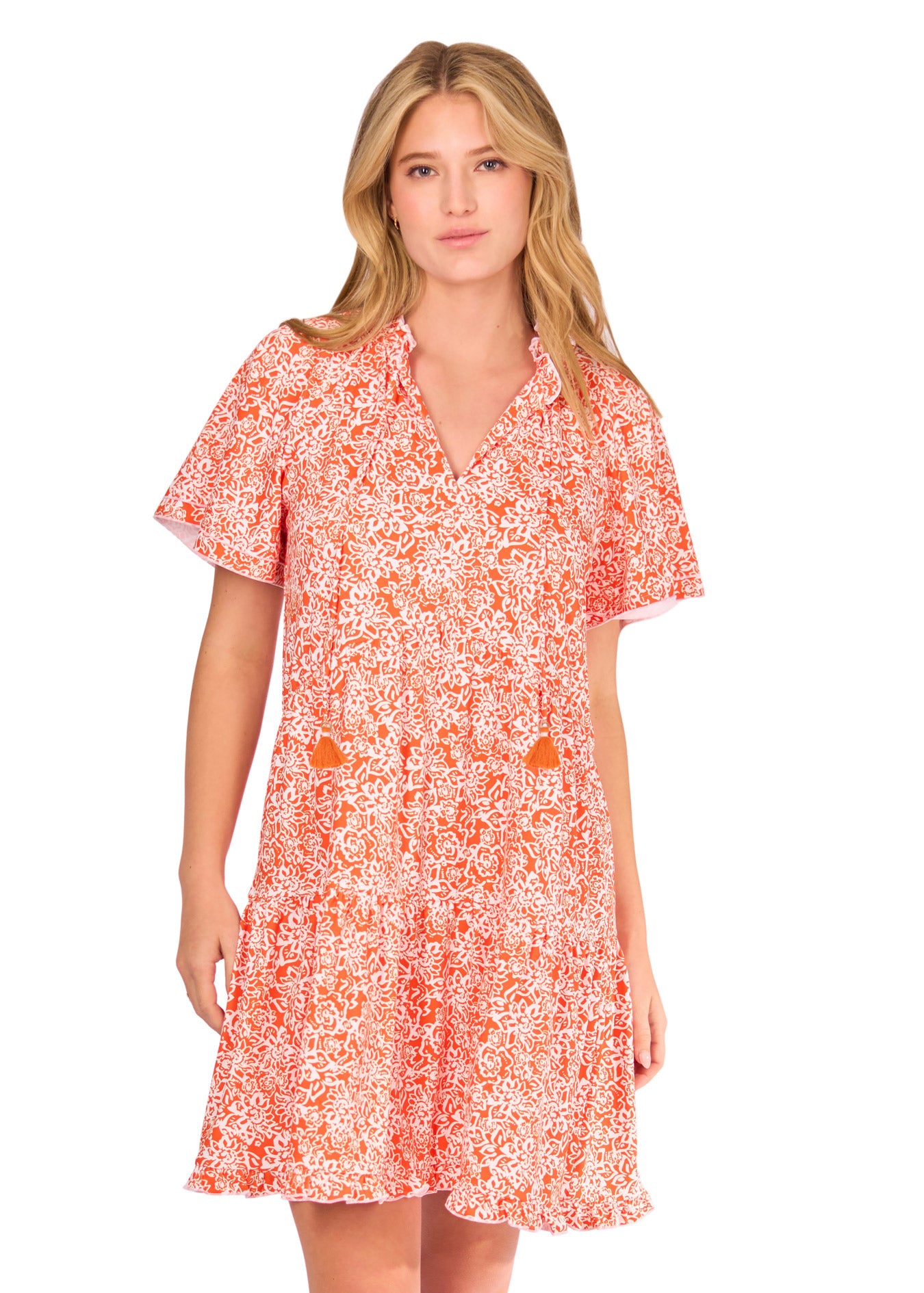 A blonde woman wearing the sun protective Orange Short Sleeve Tiered Dress from Cabana Life on a white background.