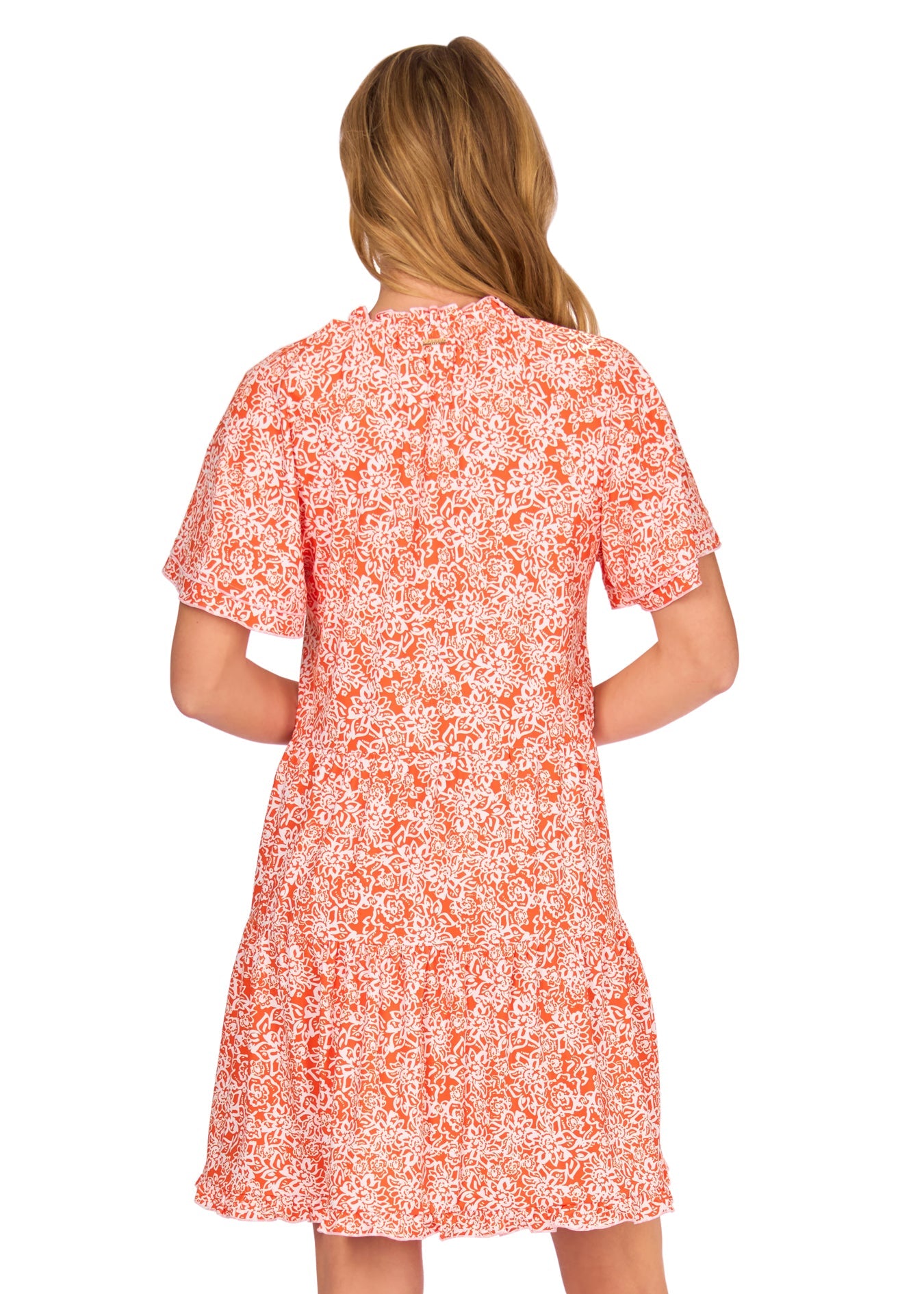 The back of a blonde woman wearing the sun protective Orange Short Sleeve Tiered Dress from Cabana Life on a white background.