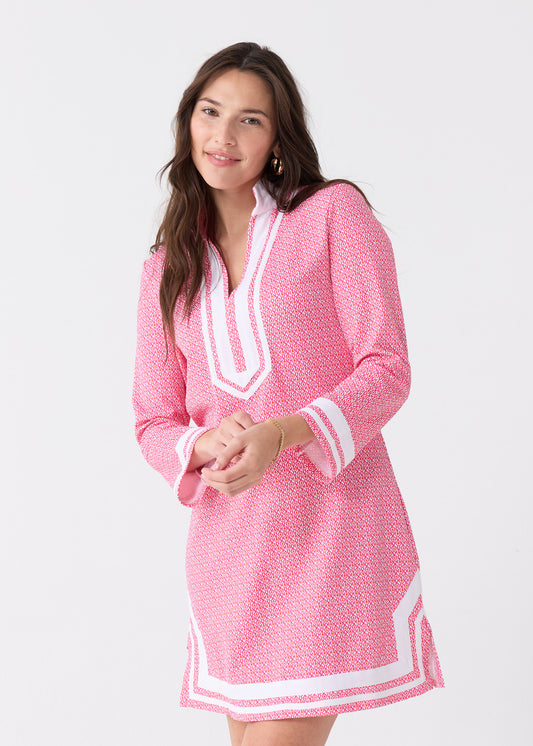 A dark haired woman smiling with hands in front wearing the Cabana Life sun protective Amelia Island Pique Tunic Dress.