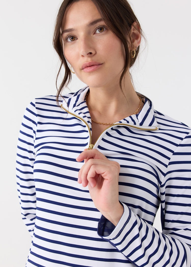 A dark haired woman wearing the Cabana Life sun protective Navy Stripe 1/4 Zip Sport Dress with gold jewelry.