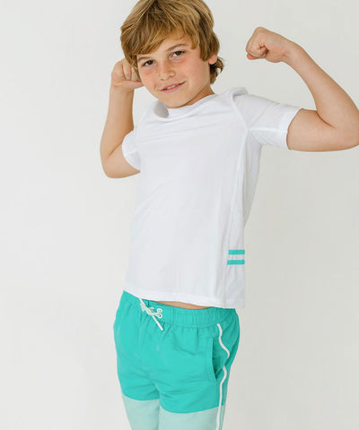 A boy wearing Cabana Life's sun protective swimwear.