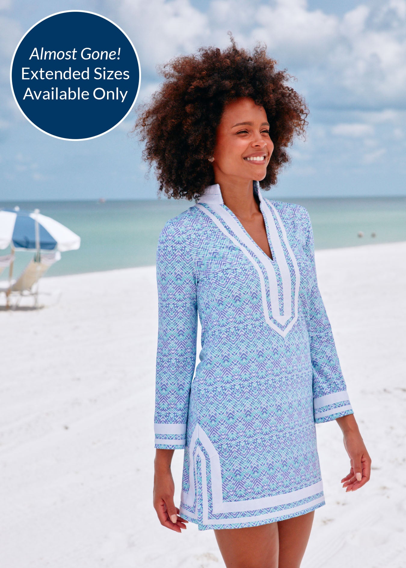 A black woman on beach wearing Cabana Life sun protective Naples with white trim terry tunic.