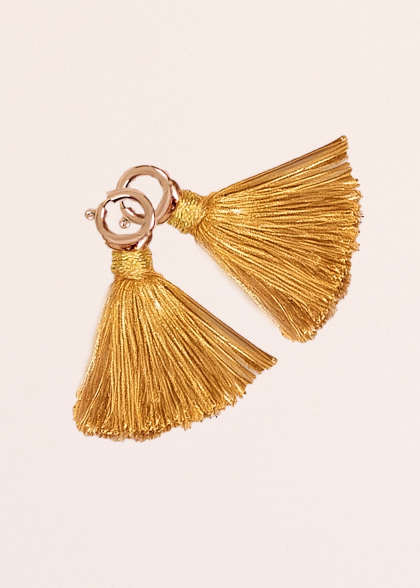 Cabana Life's Gold Game Day Tassel Set on top of each other on a white background.