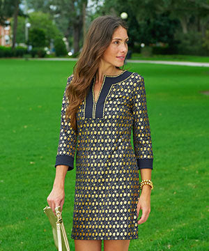 A woman wearing the Cabana Life sun protective Black Metallic Tunic Dress in a park.