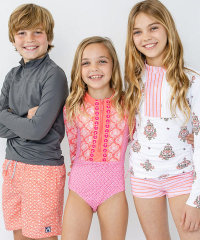 Kids wearing coordinating sun protective swimwear from Cabana Life.