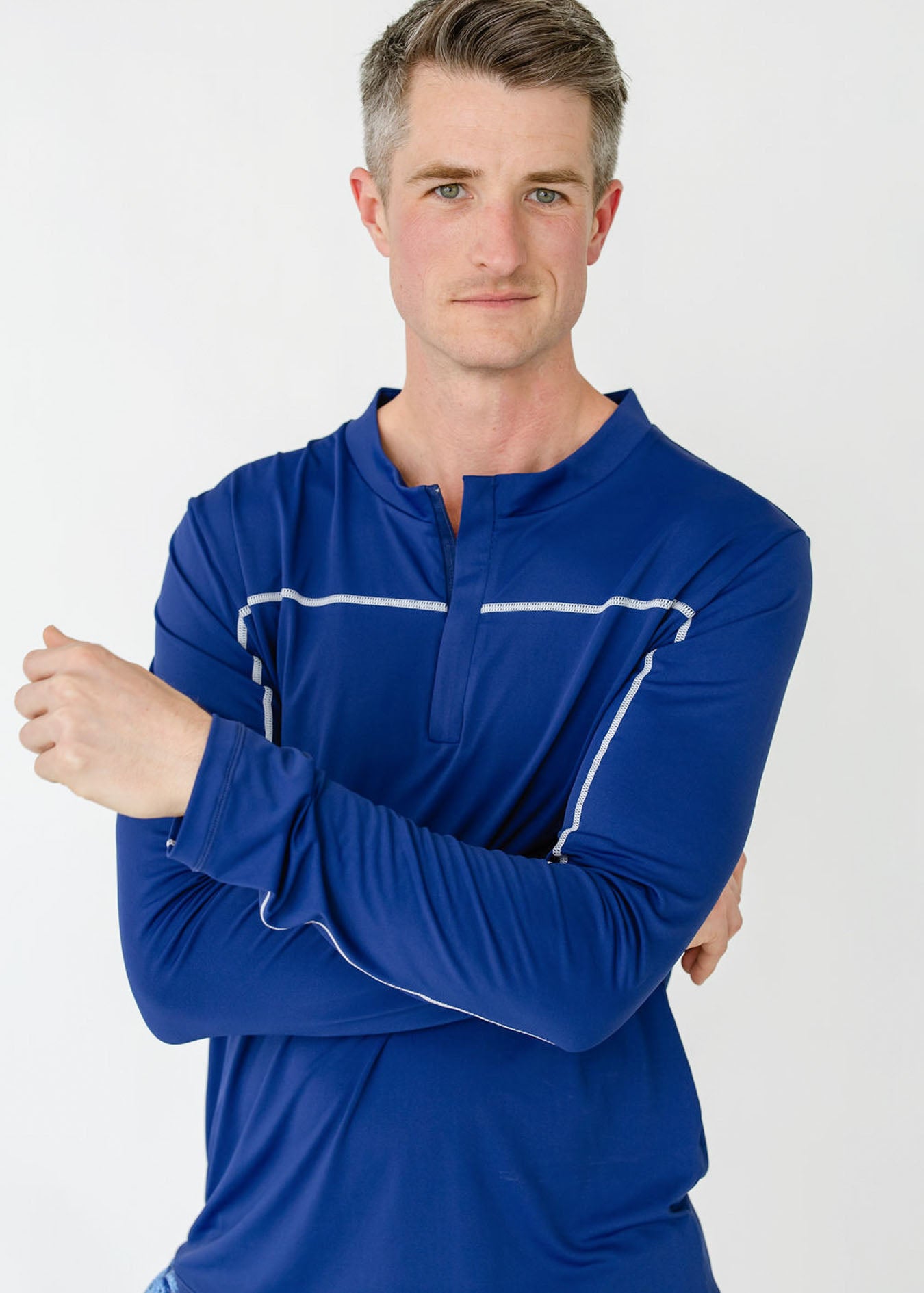 A man wearing the sun protective Men's Navy Sport Zip Top from Cabana Life.