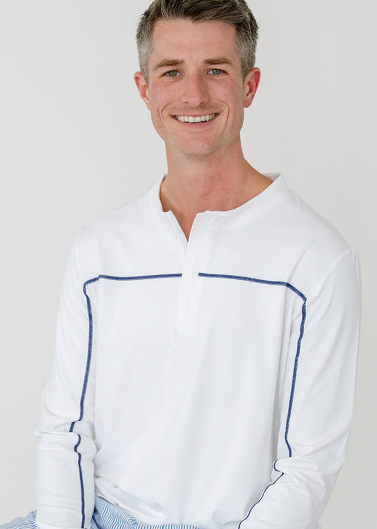 A man wearing the sun protective Men's White Sport Zip Top from Cabana Life.