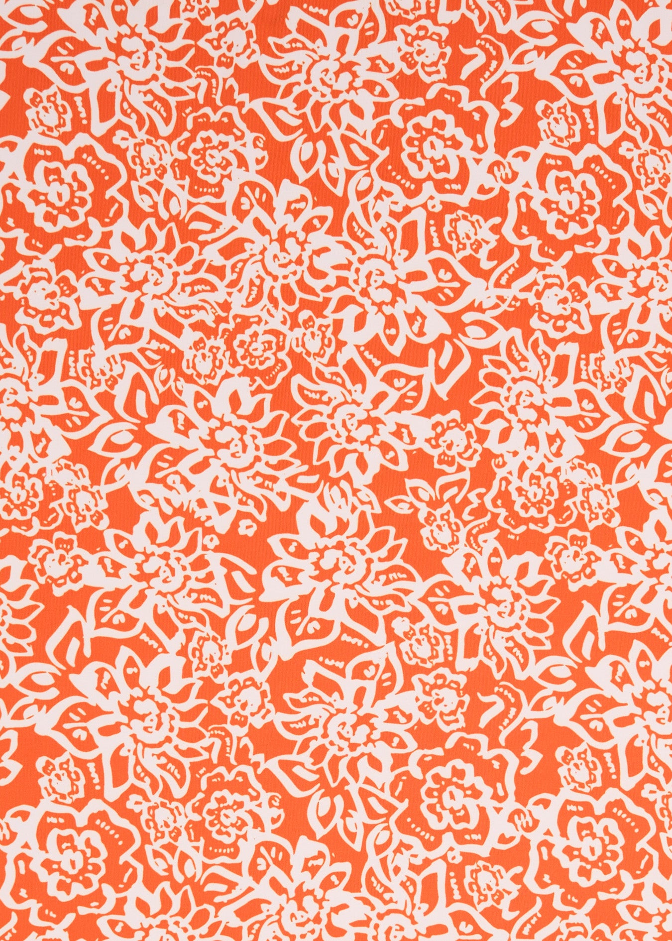 A close up of the orange and white printed Cabana Life sun protective fabric on the Orange floral Game Day print.