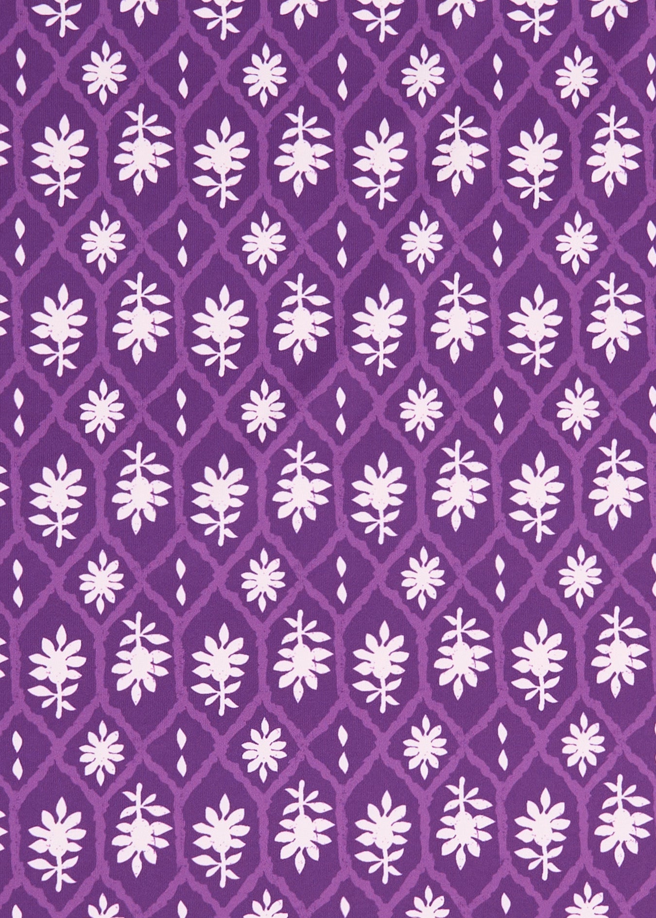 A close up of the purple and white printed Cabana Life sun protective fabric on the Purple Game Day Sleeveless Tunic Dress.