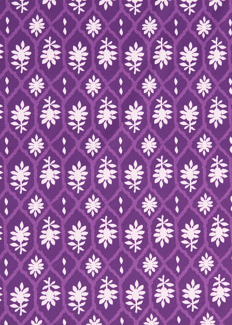 A close up of the purple and white printed Cabana Life sun protective fabric on the Purple Game Day Sleeveless Tunic Dress.