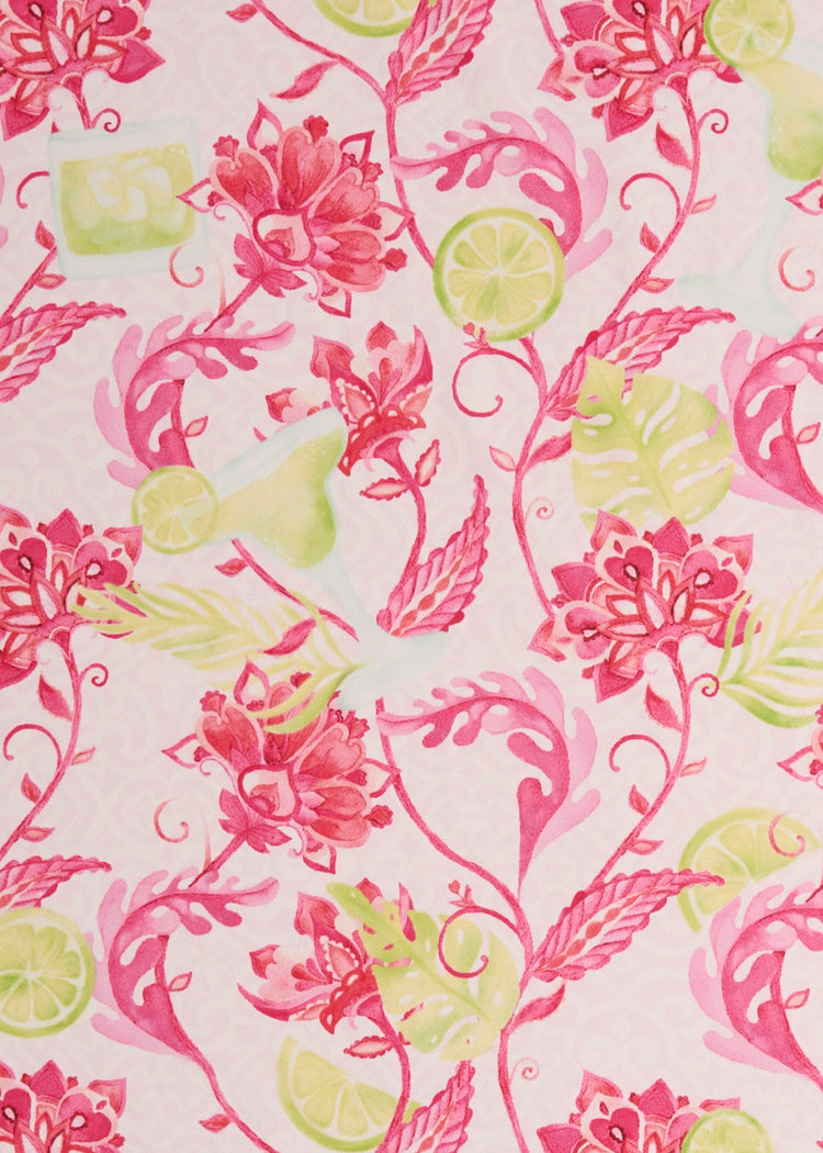 A close-up of Cabana Life's sun protective Margarita print fabric with pink flowers and lime margarita drink accents.