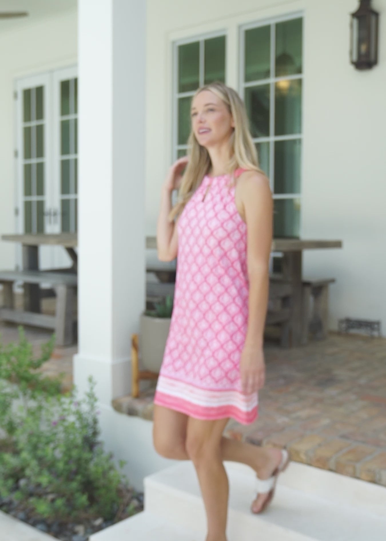 A woman walking outside in the Cabana Life sun protective Amelia Island Sleeveless Shift Dress.