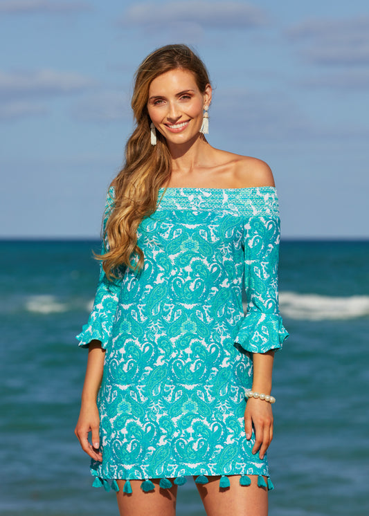 Woman standing by the ocean wearing St. Pete Off The Shoulder Dress.